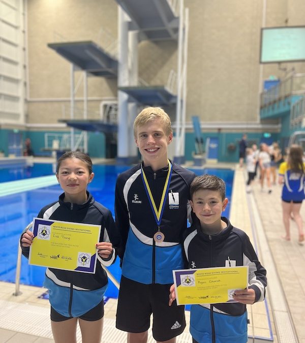 Three White Rose CDT divers on poolside with medals